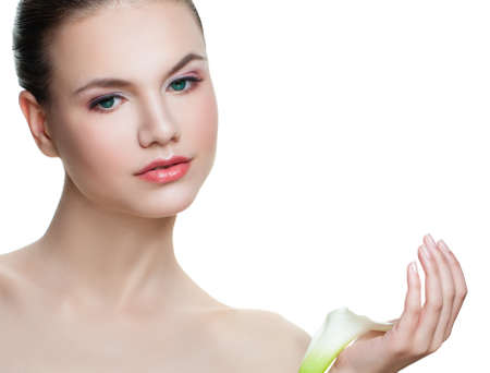 Cute woman with healthy skin and white flower isolated on white background. Skin care and spa conceptの写真素材