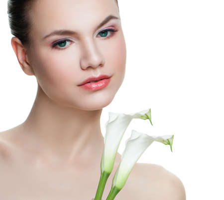 Spa woman face isolated on white background. Girl with white flowersの写真素材