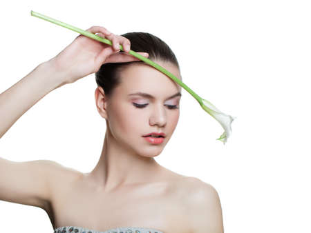 Fashion girl with white calla lily flower isolated on white backgroundの写真素材