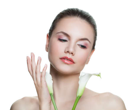 Isolated young woman with white flowers. Facial treatment, cosmetology, beauty, skincare and spa conceptの写真素材