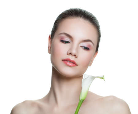 Young healthy woman portrait. Female face with white flower isolated on white background. Facial treatment, cosmetology, beauty, skincare and spa conceptの写真素材