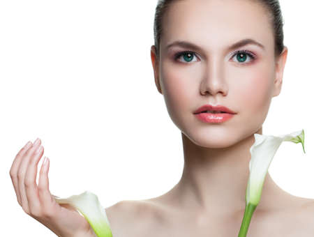Perfect young woman holding flowers isolated on white background. Beautiful female face with healthy skin. Facial treatment, cosmetology, beauty, skincare and spa conceptの写真素材