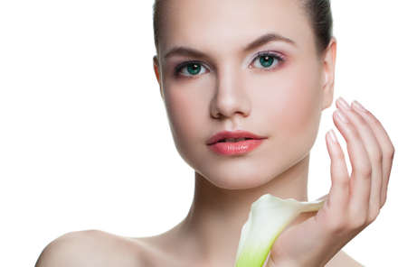 Perfect girl with white flower. Spa woman face isolated on white backgroundの写真素材