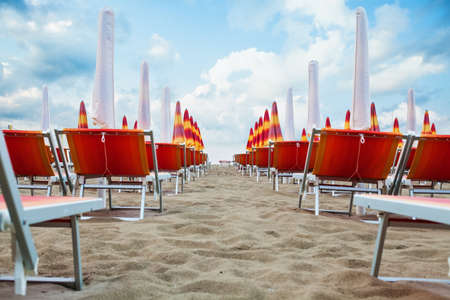 Morning on the beach. Sand, beach lounger and umbrella.の写真素材