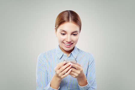 Girl with phone. Happy woman using smart phoneの写真素材