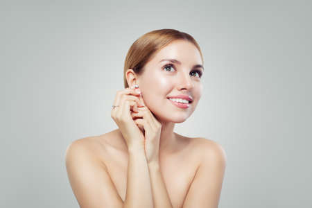 Perfect young woman with diamond earrings and ring, luxury jewelry modelの写真素材