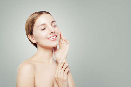 Beautiful girl relaxing. Woman face with healthy clear skin, eyes closed. Skincare and cosmetology concept.の写真素材