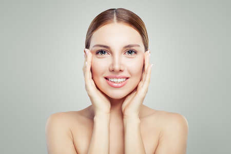 Pretty woman face. Perfect model girl with healthy clear skin. Facial lifting, skin care and cosmetology concept.の写真素材