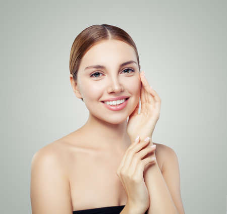 Young smiling woman. Perfect girl with clear skin and cute smile. Skincare and cosmetology concept.の写真素材