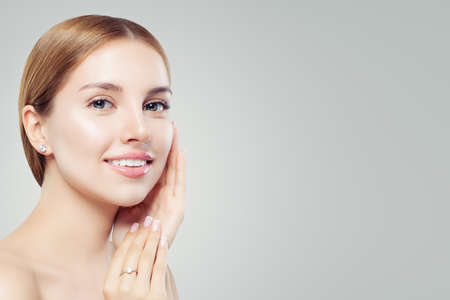 Women earring and ring. Jewelry model. Beautiful woman with diamond earrings and perfect ring, closeup portraitの写真素材