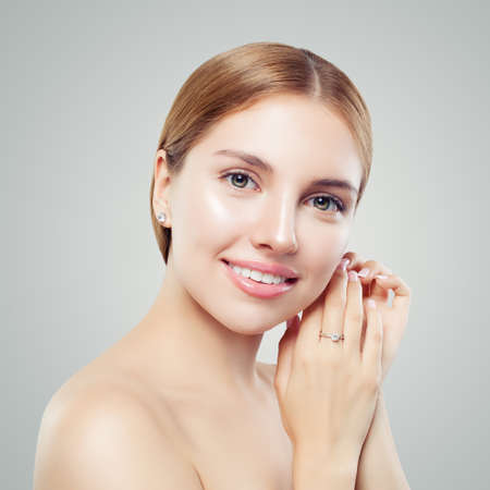 Ladies jewellery concept. Jewelry model wearing diamond earrings and luxurious ringの写真素材