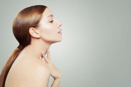 Healthy woman. Pretty face, female profile on white background with copy space. Facial treatment, skincare and cosmetologyの写真素材