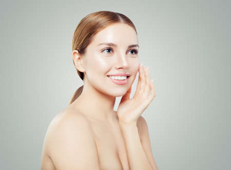 Happy woman spa model portrait. Smiling girl with healthy clear skin on whiteの写真素材