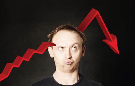 Business man and red arrow. Crash of investments and crisis conceptの写真素材