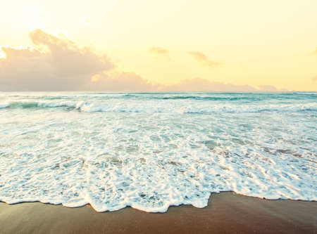 Sea and beach background. Skyline with sky clouds, sea surf and sand
