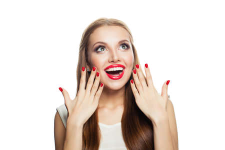 Surprised excited model isolated on white background. Laughing woman looking upの写真素材