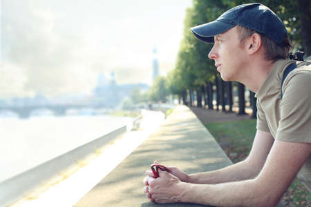 Tourist enjoying a city view from quay, taking a break and relaxingの写真素材