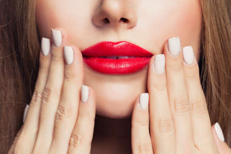 Manicure nails and red female lipsの写真素材