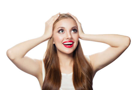 Happy surprised woman looking up  isolated on white backgroundの写真素材