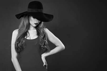 Retro style portrait of beautiful woman model in hat. Black and white photoの写真素材