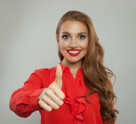 Thumb up sign. Female hand showing thumb upの写真素材