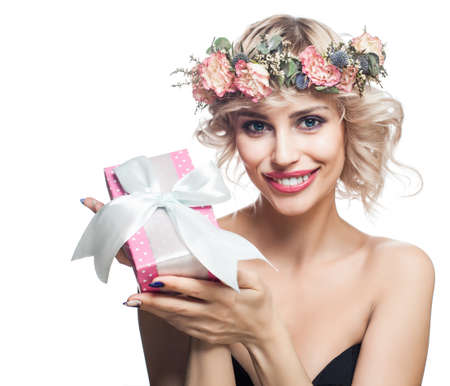 Happy woman with gift box and flowers isolated on whiteの写真素材