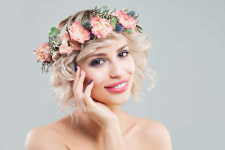 Beauty Fashion Portrait of Beautiful Model Woman with Curly Hair, Makeup and Flowers Crownの写真素材