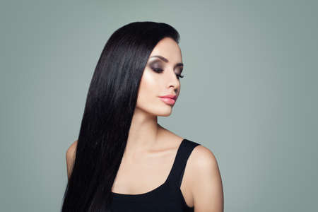 Beautiful woman with long healthy straight hair and makeup portraitの写真素材