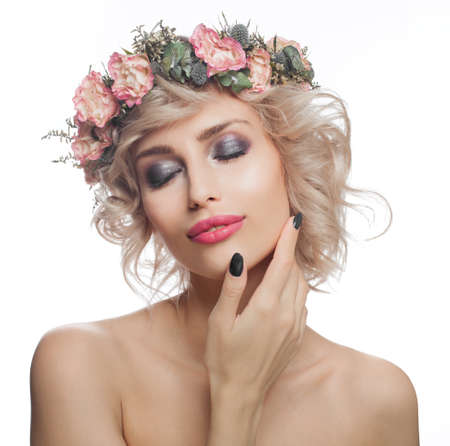 Portrait of beautiful woman model with makeup, blonde curly hair and flowers isolated on whiteの写真素材