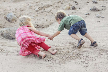 One child helping the other child. Help conceptの写真素材