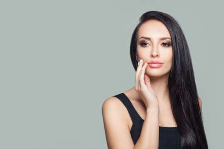 Beautiful girl brunette with straight hair portraitの写真素材