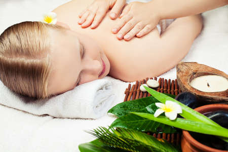 Spa massage with aromathrepy. Beautiful young woman getting spa massage. Spa conceptの写真素材