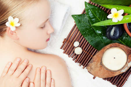 Spa relax massage concept. Beautiful young woman getting spa massage. Top viewの写真素材