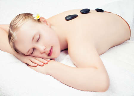 Spa massage procedure. Beautiful young woman getting spa massage. relax conceptの写真素材