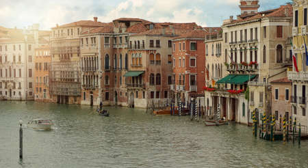 Venetian gondola and boats in big canal waters of Venice Italy. Street in water cityの写真素材