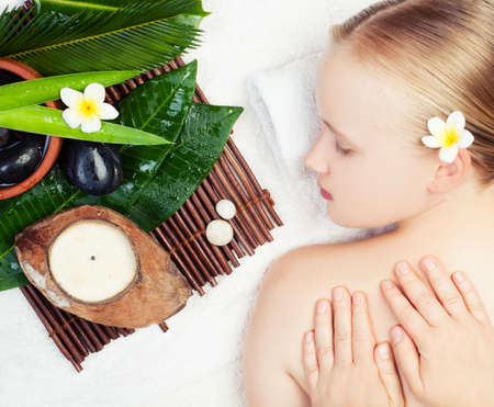 Spa massage concept. Beautiful young woman getting spa massage. Top viewの写真素材