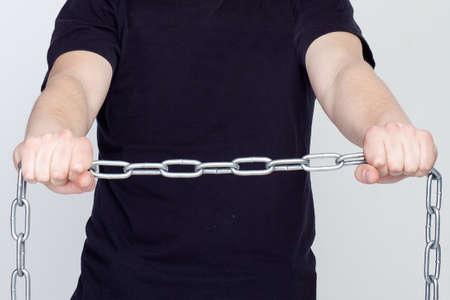 Man and iron chains. The concept of freedom and slaveryの写真素材