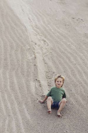 Child coming down on sand at sand Mountain.の写真素材
