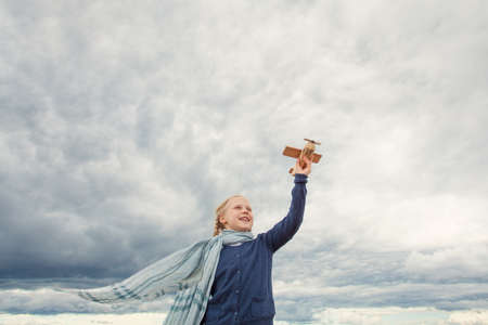 Traveling and freedom concept. Girl in blue jacket and airplaneの写真素材
