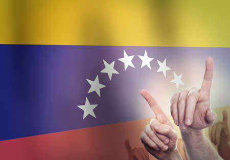 Hands on the background of the Venezuela flag. Freedom conceptの写真素材