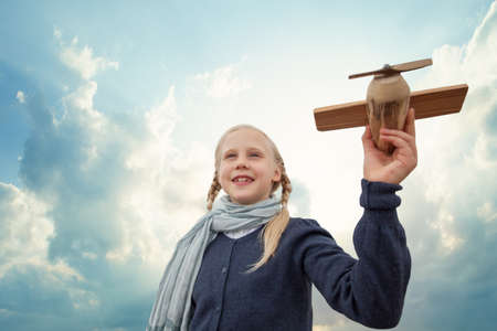 Traveling and freedom concept. Girl in blue jacket and airplaneの写真素材