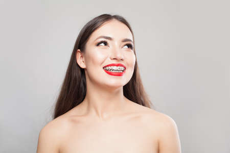 Smiling woman in braces on whiteの写真素材