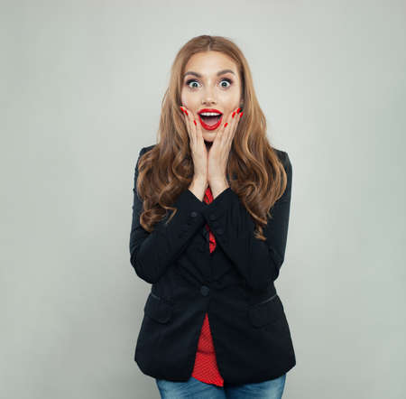 Happy surprised woman on white backgroundの写真素材