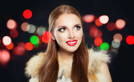 Beautiful woman on colorful nightly backgroundの写真素材