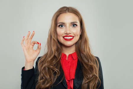 Happy woman showing ok gesture. Facial expressions and emotionsの写真素材