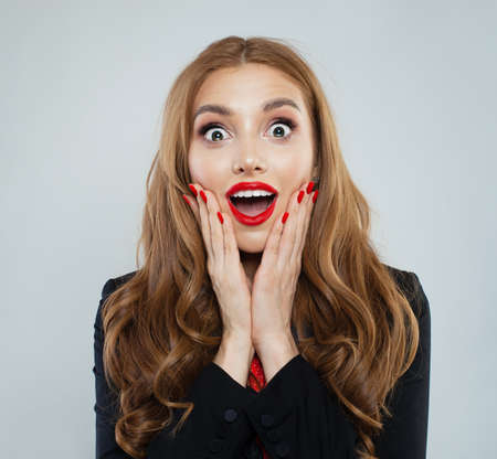 Happy excited surprised woman portraitの写真素材