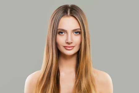 Healthy woman portrait. Beautiful model with clear skin and long shiny brown hairの写真素材