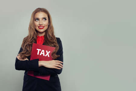 Business woman with red taxes report on gray banner background. Businesswoman in black suit portraitの写真素材