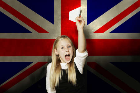 Happy kid with plane against UK flagの写真素材