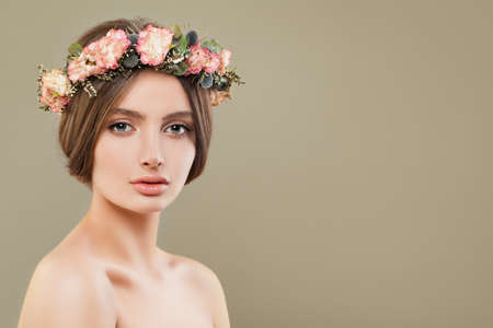 Young woman spa model with clear skin wearing flowers crown. Beautiful face closeupの写真素材